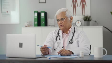 Médico-Senior-Indio-Que-Consulta-Al-Paciente-En-Videollamada