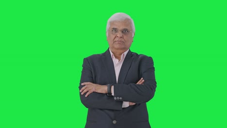 Indian-senior-businessman-standing-crossed-hands-Green-screen