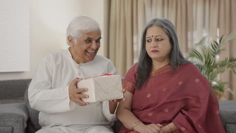 Cute-Old-Indian-husband-giving-a-gift-to-his-wife