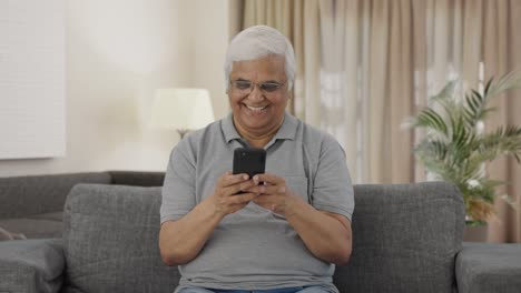 Happy-Indian-old-man-chatting-on-phone