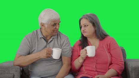 Happy-Indian-old-couple-drinking-tea-and-talking-Green-screen