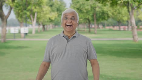 Happy-Indian-old-man-getting-a-surprise-in-park