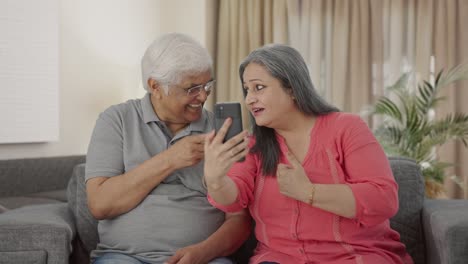 Happy-Old-Indian-couple-talking-on-video-call