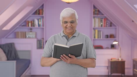 Happy-Indian-old-man-reading-a-book