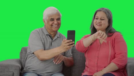 Happy-Old-Indian-husband-clicking-pictures-of-his-wife-Green-screen