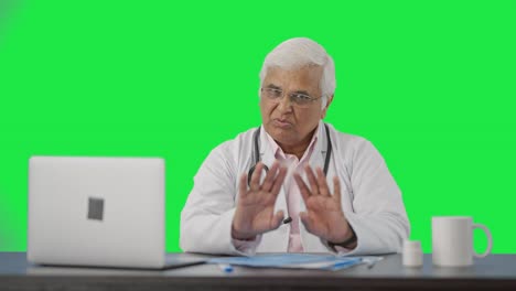 Indian-senior-doctor-talking-to-the-patient-Green-screen