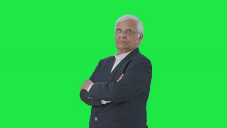 Portrait-of-Indian-senior-journalist-standing-crossed-hands-Green-screen