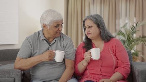 Happy-Indian-old-couple-drinking-tea-and-talking