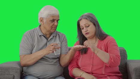 Old-Indian-husband-giving-medicine-to-his-sick-wife-Green-screen