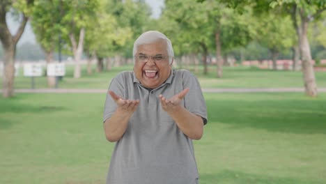 Happy-Indian-old-man-making-fun-of-somebody-in-park