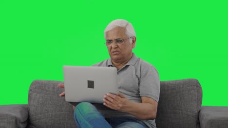 Indian-old-man-talking-on-video-call-on-laptop-Green-screen