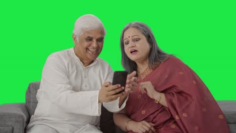 Happy-Old-Indian-husband-clicking-picture-of-his-wife-Green-screen