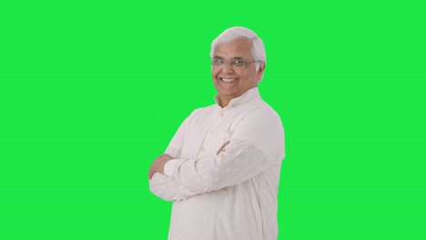 Portrait-of-Happy-Indian-old-man-standing-crossed-hands-Green-screen