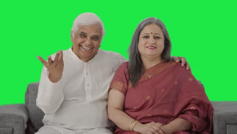 Happy-Old-Indian-couple-talking-to-the-camera-Green-screen