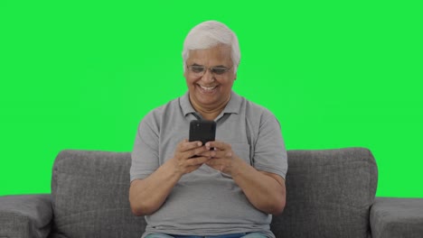 Happy-Indian-old-man-chatting-on-phone-Green-screen