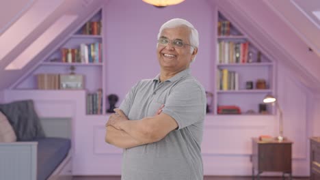 Portrait-of-Happy-Indian-old-man-standing-crossed-hands