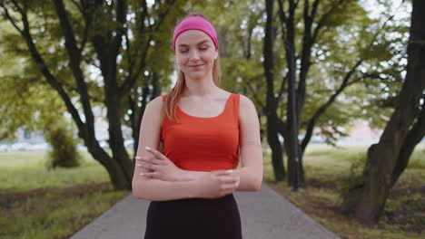 Athletic-fitness-concentrat-runner-girl-training-looking-at-camera,-marathon-achievement-in-park