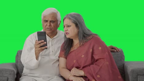 Angry-Old-Indian-couple-shouting-on-video-call-Green-screen