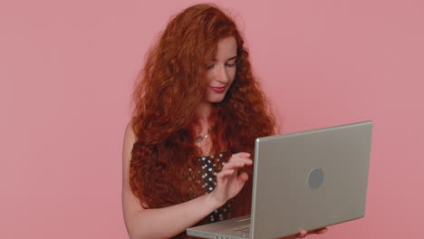 Redhead-girl-working-online-on-laptop-showing-thumb-up-positive-good-feedback,-like,-lottery-win