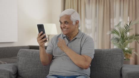 Happy-Indian-old-man-talking-on-video-call