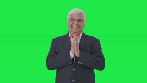 Happy-Indian-senior-manager-greeting-and-doing-Namaste-Green-screen