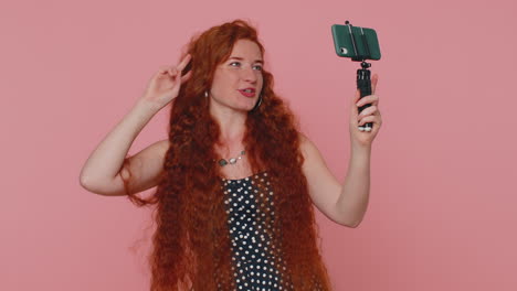 Girl-blogger-take-selfie-on-mobile-phone-selfie-stick-communicate-video-call-online-with-subscribers