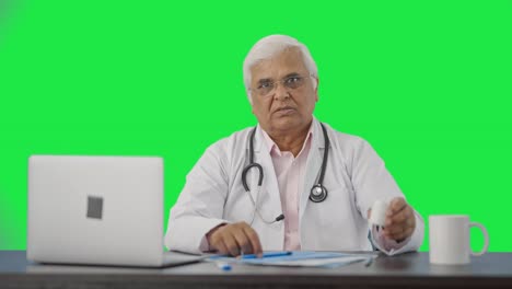 Indian-senior-doctor-explaining-reports-to-the-patient-Green-screen