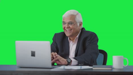 Happy-senior-Indian-manager-doing-a-video-call-Green-screen