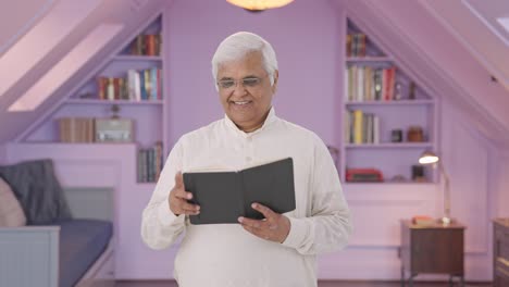 Happy-Indian-old-man-reading-a-book