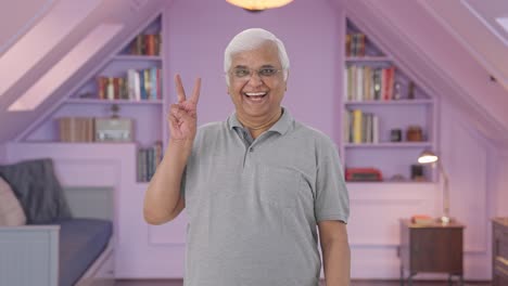 Indian-old-man-showing-victory-sign