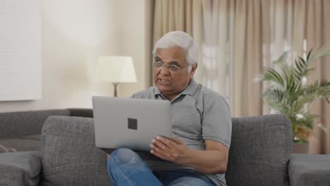 Angry-Indian-old-man-shouting-on-video-call-on-laptop