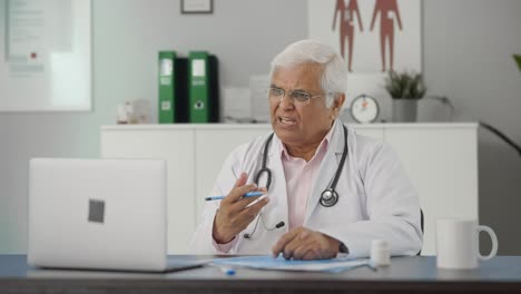 Angry-Indian-senior-doctor-consulting-patient-on-video-call