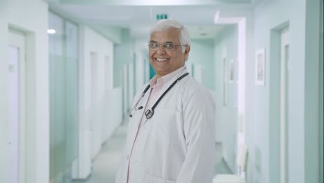 Portrait-of-Happy-Indian-senior-doctor-getting-ready