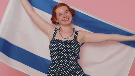 Happy-young-woman-in-dress-waving-and-wrapping-in-Israel-national-flag,-celebrating-Independence-day