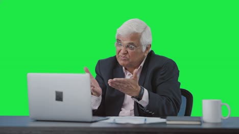 Angry-senior-Indian-manager-doing-a-video-call-Green-screen