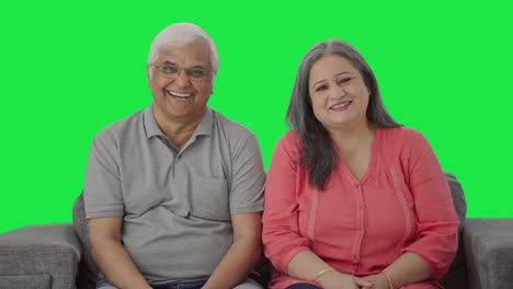 Happy-Indian-old-couple-talking-to-someone-Green-screen