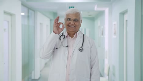 Happy-Indian-senior-doctor-showing-okay-sign