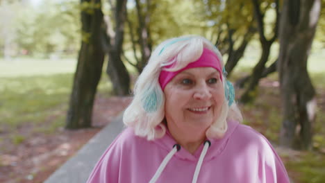 Senior-athletic-woman-grandmother-running-jogging-in-park-during-morning-workout-cardio-outdoors