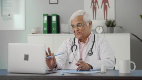 Happy-Indian-senior-doctor-consulting-patient-on-video-call