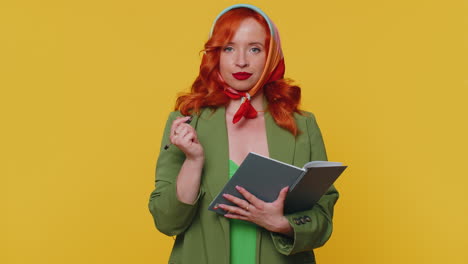 Thoughtful-journalist-redhead-woman-making-notes,-writing-down-thoughts-with-pen-into-notebook-diary