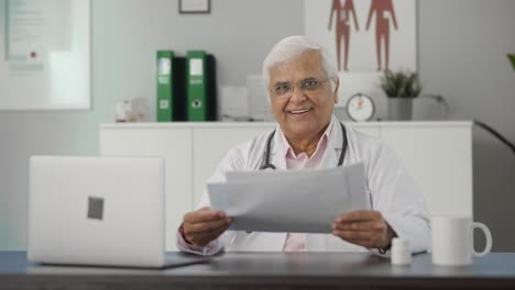 Happy-Indian-senior-doctor-discussing-reports-with-the-patient