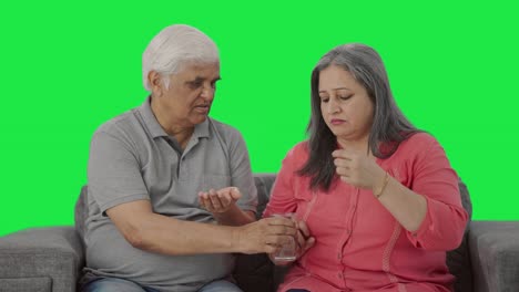 Old-caring-Indian-husband-giving-medicine-to-his-sick-wife-Green-screen