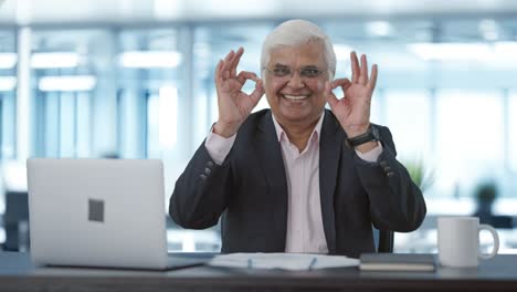 Happy-senior-Indian-businessman-showing-okay-sign