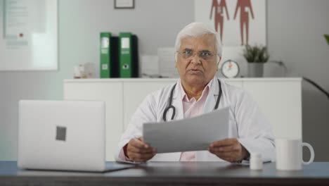 Sad-Indian-senior-doctor-discussing-reports-with-the-patient