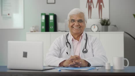 Happy-Indian-senior-doctor-putting-stethoscope-on-shoulders