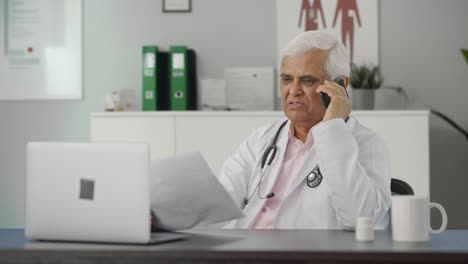 Indian-senior-doctor-explaining-reports-to-the-patient-over-call