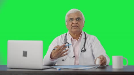 Angry-Indian-senior-doctor-explaining-reports-to-the-patient-Green-screen