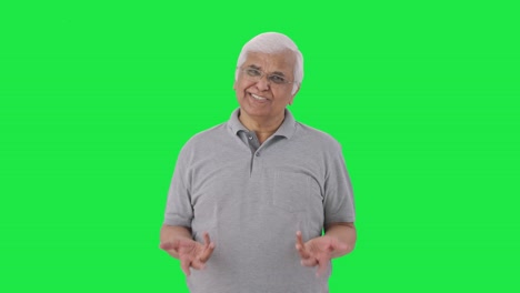 Happy-Indian-old-man-talking-to-someone-Green-screen