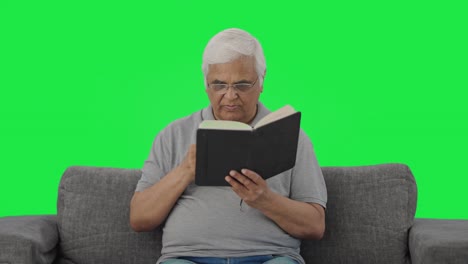 Serious-Indian-old-man-reading-book-in-morning-Green-screen