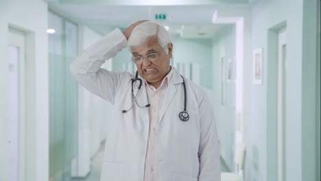 Tensed-Indian-senior-doctor-thinking-something